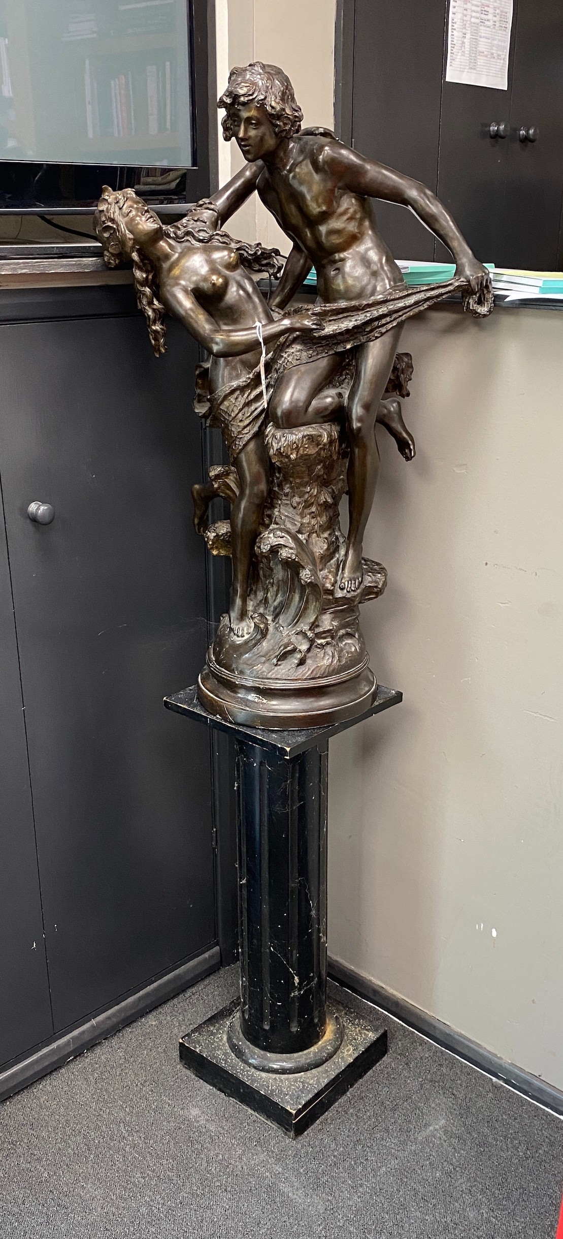 A bronzed metal group of a dancing couple on associated wood plinth combined height 170cm